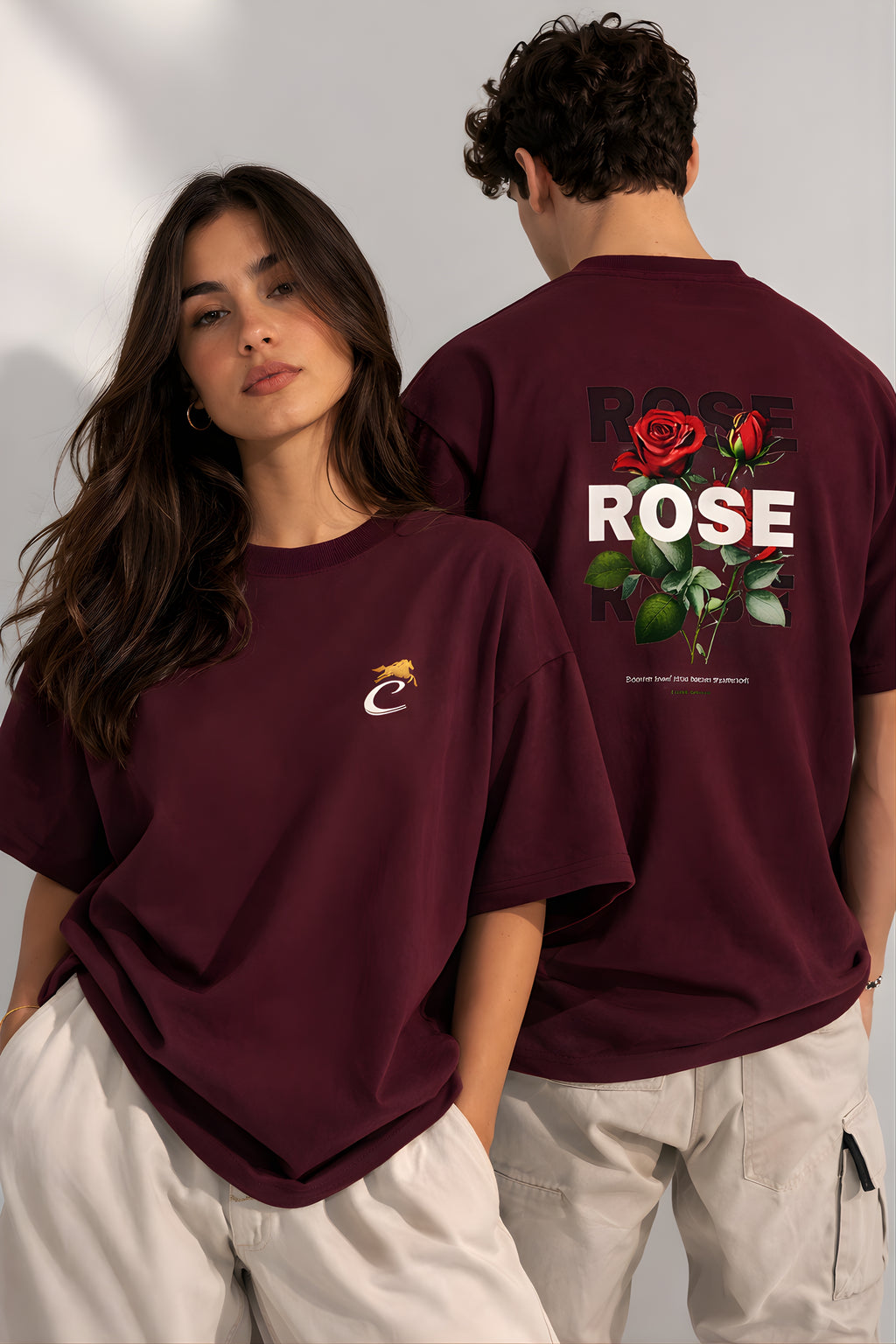 Couple wearing burgundy oversized terry t-shirt with front logo and rose graphic back print streetwear fashion
